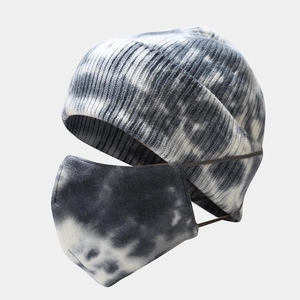 Detailed view of grey tie-dye knitted beanie and face mask set with ribbed texture