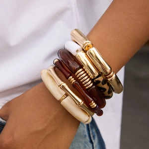 Stack of vintage bamboo style resin and gold-plated bracelets featuring leopard prints