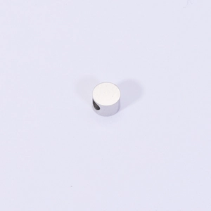 Close-up of polished 316L stainless steel spacer bead with side hole for DIY jewelry