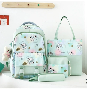 Detail of mint green four-piece backpack set featuring cute cartoon bear and canvas texture