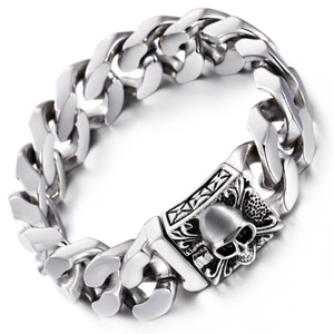 Close-up of gothic silver skull buckle on a thick punk style Cuban link bracelet