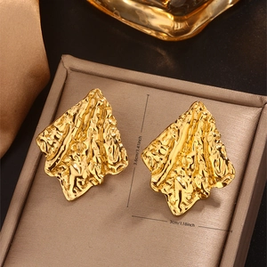 Macro view of 18K gold plated textured geometric earrings with vintage hammered finish
