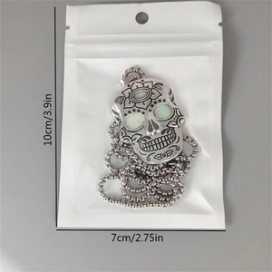 Luminous sugar skull pendant in silver finish with dimensions of 10cm by 7cm
