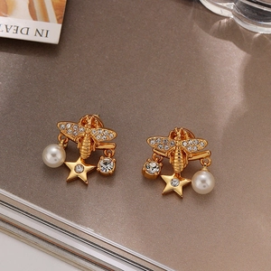 Elegant gold bee and star earrings with white crystals and faux pearl accents