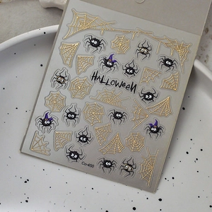Metallic gold and black Halloween nail stickers with spiders and webs on white plate