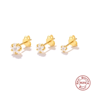 Detailed macro of three gold S925 sterling silver star stud earrings with zircon stones