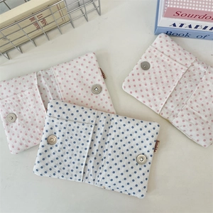 Detail of fabric passport holder with star embroidery and metal button closure