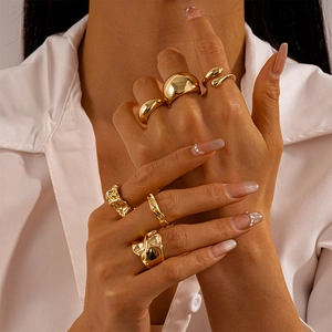 6-piece gold geometric ring set with smooth and lava textures on female hand model