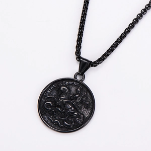 Detail of Saint George dragon slayer relief on black stainless steel coin pendant