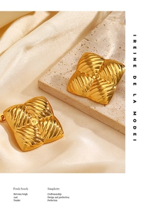 Detailed close-up of vintage golden square earrings with elegant spiral embossed texture