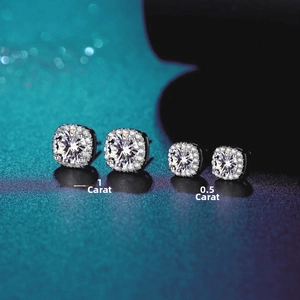 Macro shot of two pairs of square halo moissanite earrings in 1 carat and 0.5 carat sizes
