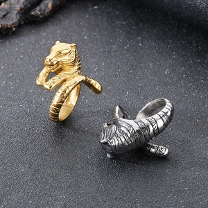 Macro detail of punk tiger head rings in gold and silver finish stainless steel
