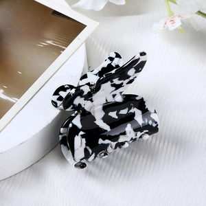 Detailed macro view of heart hair clip with black and white marble leopard pattern