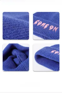 Detailed knit texture and pink letter embroidery on cobalt blue winter beanie cap
