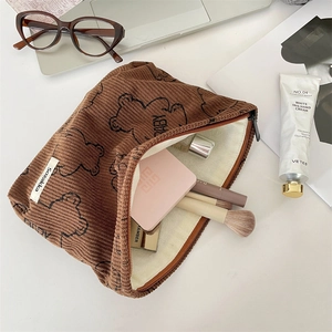 Detailed view of printed corduroy makeup bag with cute bear pattern and inside storage