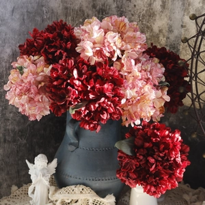 Detailed view of vintage faux hydrangeas in a ceramic vase with oil painting aesthetic