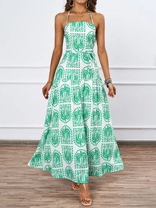 Detail of tropical palm print on white halter maxi dress with tied waist belt