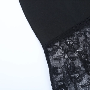 Macro shot of fine black lace stitching and fabric detail on elegant evening dress