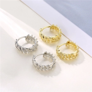 Twisted 18K gold and silver hoop earrings with textured spiral and bead pattern