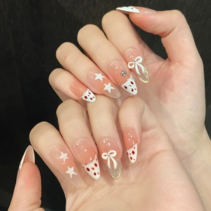 Pink almond press-on nails with 3D white bows, stars, and red polka dot French tips
