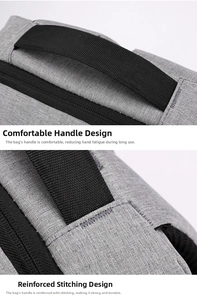 Detail of reinforced stitching and durable nylon handle on a gray laptop backpack
