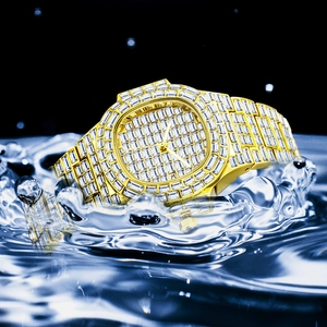 Close-up of golden diamond watch splashing in water with high-speed motion detail
