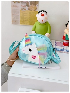 Blue unicorn crossbody bag with glitter horn and mesh mane detail on white surface