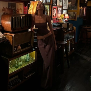Detail of a dark brown two-piece set featuring a slim camisole and maxi skirt with tie waist
