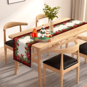 Detailed texture of Christmas table runner with poinsettia, pinecones and plaid patterns