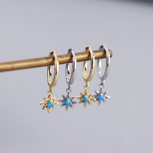 Detail of S925 silver star earrings with vibrant blue opal in gold and silver finishes