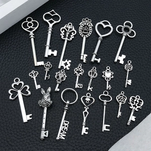 Macro shot of 19 assorted vintage silver alloy key charms for DIY jewelry making