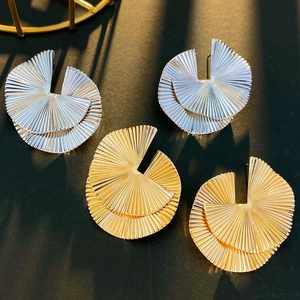 Textured gold and silver fan-shaped alloy earrings with elegant sunburst pleats