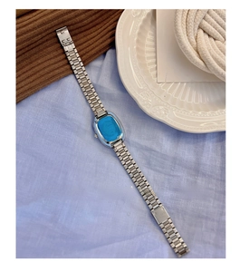 Close-up of vintage steel chain watch with stainless steel engraving on the folding clasp