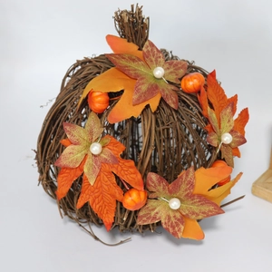 Close-up of rustic maple leaves, mini pumpkins, and white berries on a wood candle ring