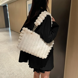 Stylish white plush tote bag with striped texture and fuzzy ball chain strap for women