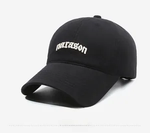 Detail of white narason letter embroidery on a black cotton baseball cap