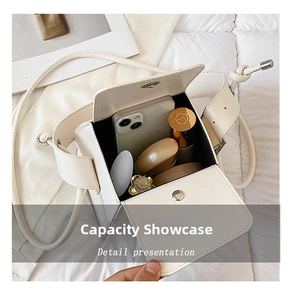 Internal view of a white PU leather box bag showing capacity for phone and cosmetics