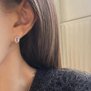 Minimalist 925 sterling silver oval zircon stud earrings worn by model for elegant style