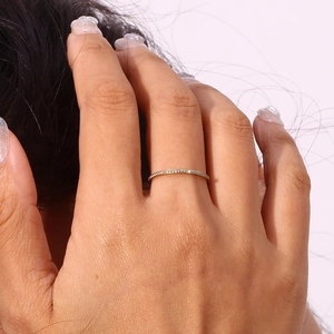 Close-up of minimalist gold-plated stainless steel ring with micro-set zircon on hand