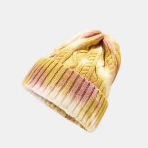 Close-up of cable knit texture on tie-dye winter beanie with gradient yellow and purple