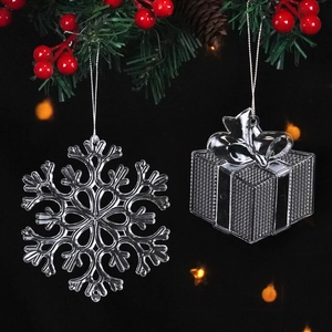 Close-up of transparent acrylic snowflake and gift box ornaments for Christmas decor