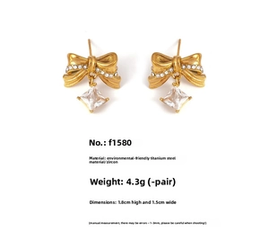 Detail view of gold bow earrings with cubic zirconia and dimension labels 1.8x1.5cm