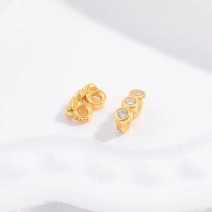 Macro view of gold plated S925 silver spacers with embedded white cubic zirconia stones