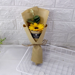 Detailed view of artificial sunflower bouquet with eucalyptus in kraft paper wrap