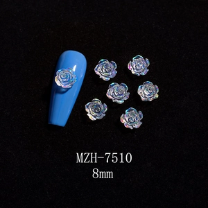 Macro detail of 8mm 3D aurora resin rose nail charms with iridescent shimmer effect