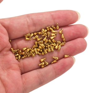 Golden stainless steel water drop pendants held in hand for DIY jewelry making