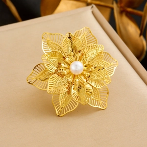 Close-up of gold-plated hollow petal ring featuring a central white pearl inlay
