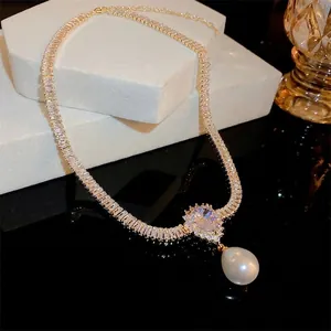 Gold-plated necklace featuring square-cut zircons and an elegant teardrop pearl pendant