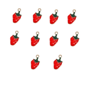 Macro detail of red strawberry alloy charms with green leaves for DIY jewelry making