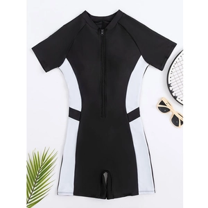 Flat lay of athletic color-block one-piece swimsuit with zipper and sports accessories